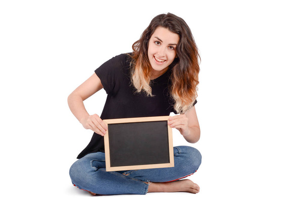 young woman holding a chalkboard on studio. - Photo, Image