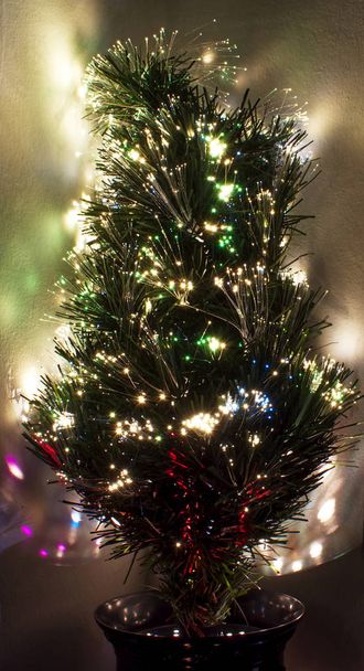 Christmas tree with fiber optic lights against clear background - Foto, Imagem
