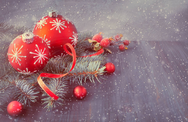 Wooden background with Christmas tree twigs decorated with Xmas  - 写真・画像