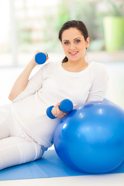 young pregnant woman exercising with dumbbells - Photo, image