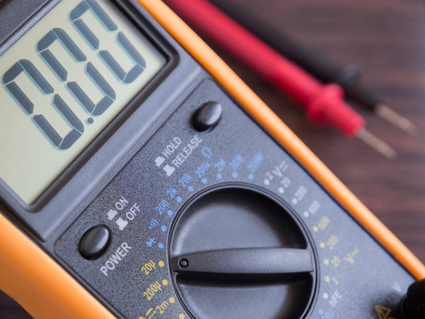 Digital Multimeter on wooden table close up. Selective focus. - 写真・画像