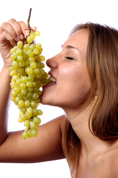 Hungry girl wants to eat delicious juicy grapes - Фото, изображение