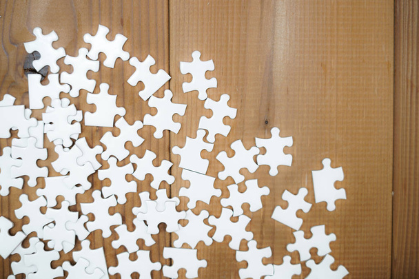 White jigsaw puzzle that has been placed on a desk - Photo, Image