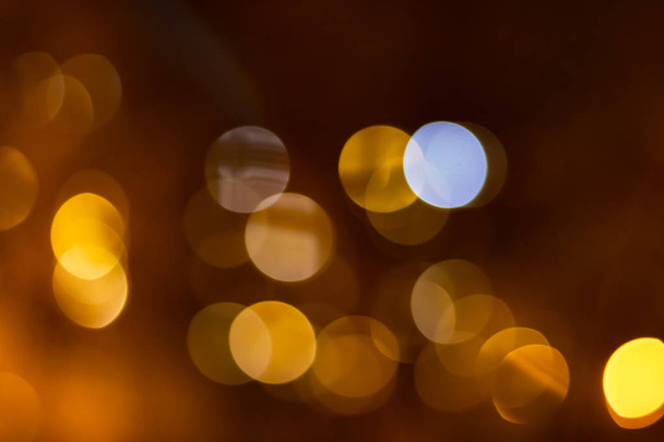 Orange bokeh of city lights on darck orange background. - Photo, Image