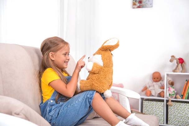 Shot of a little girl spending time at home with soft toy   - Photo, Image