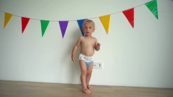 cute angry baby boy wearing diaper showing negative emotions. Gimbal motion - Footage, Video