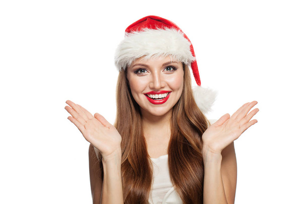 Christmas portrait of pretty surprised woman in santa claus hat  - Photo, Image
