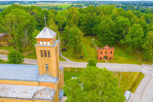 Beautiful Aerial view from drone on Akniste,  Latvia. Catholic Church In Sunny Summer Day. Architectural Heritage. - Photo, Image