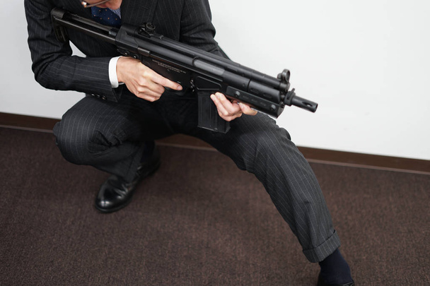 Businessman to fight with a machine gun - Photo, Image