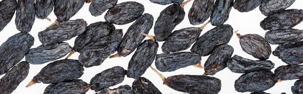 top view of black raisins isolated on white, panoramic shot - Zdjęcie, obraz