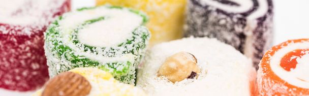 close up view of assorted delicious turkish delight in coconut flakes isolated on white, panoramic shot - Photo, Image