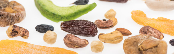 close up view of tasty assorted nuts, dried fruits and candied fruit isolated on white, panoramic shot - Photo, Image