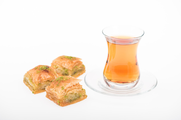 cup of tea near turkish baklava isolated on white - Fotografie, Obrázek