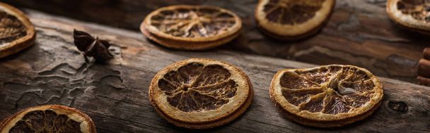 dried citrus slices with anise on wooden background, panoramic shot - Photo, Image