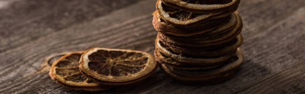 dried citrus slices on wooden brown surface, panoramic shot - Foto, imagen