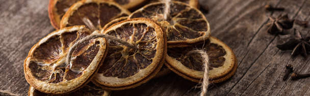 dried citrus slices on rope near anise on wooden surface, panoramic shot - Photo, Image