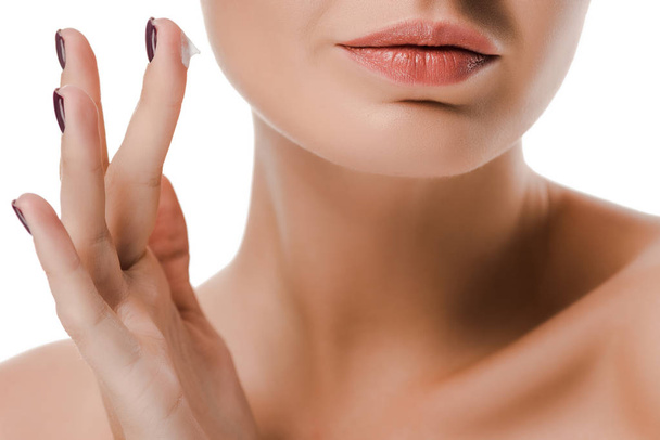 cropped view of naked woman with face cream on finger isolated on white - Φωτογραφία, εικόνα
