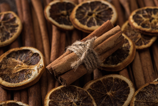 close up view of dried orange slices and cinnamon bunch - Foto, imagen