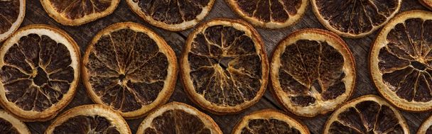 top view of dried orange slices on wooden background, panoramic shot - Foto, imagen