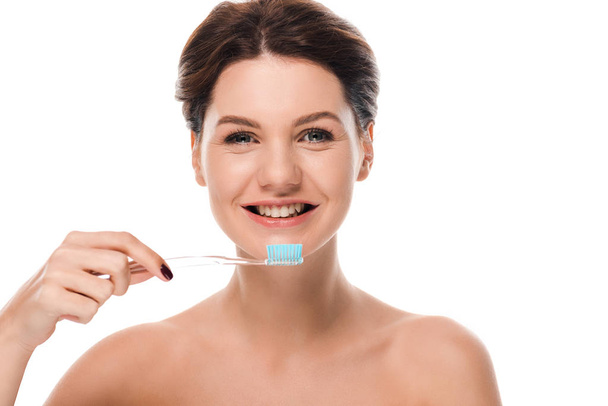 happy naked woman smiling while holding toothbrush isolated on white  - Photo, Image