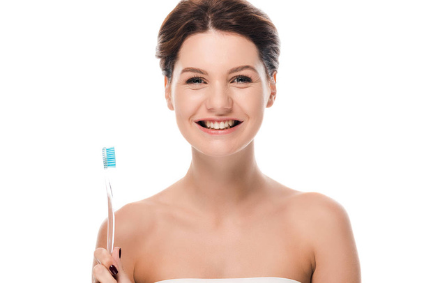 happy young woman holding toothbrush isolated on white  - Fotó, kép