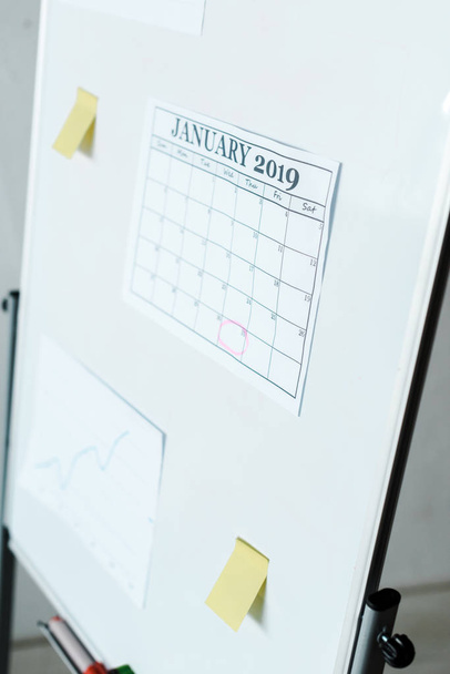 selective focus of calendar with january letters on flipboard  - 写真・画像