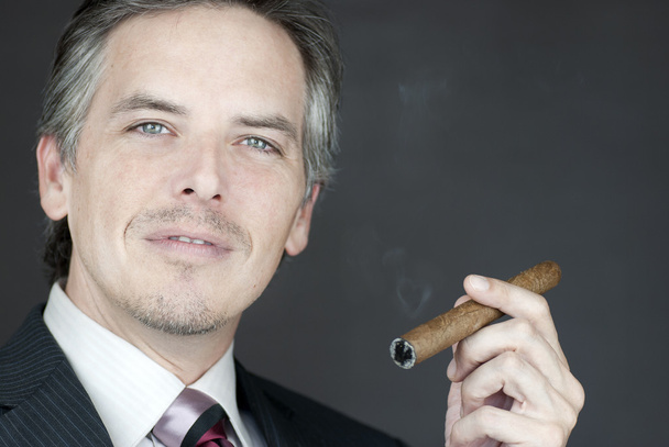 Confident Businessman Holds Cigar - Zdjęcie, obraz