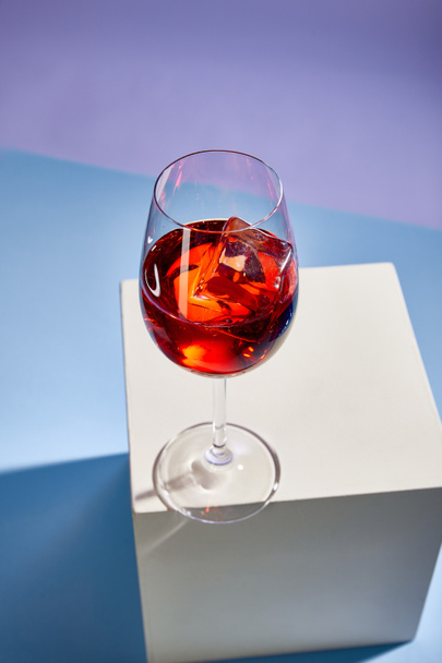 high angle view of cocktail Aperol Spritz in glass on blue background  - Foto, Imagen