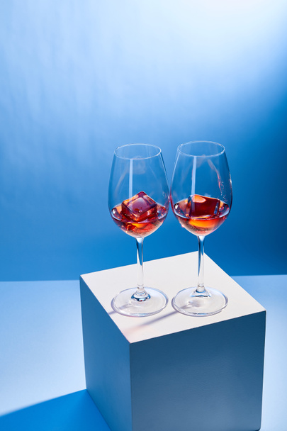 cocktails Aperol Spritz with ice cubes in glasses on blue background  - Photo, Image