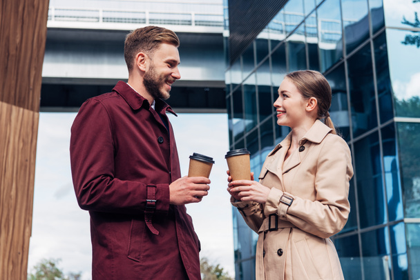 attractive woman looking at handsome man with coffee to go  - Foto, imagen