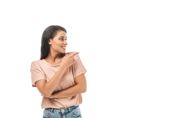 smiling african american woman looking away and pointing with finger isolated on white - Foto, Imagen