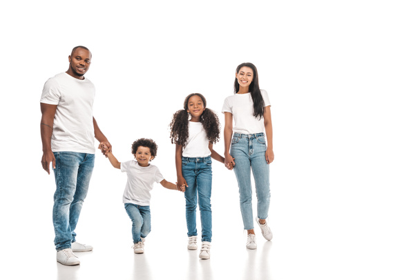 happy african american parents holding hands with daughter and son while standing on white background - Foto, Imagen
