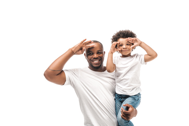cheerful african american father holding son imitating photo shooting isolated on white - Φωτογραφία, εικόνα