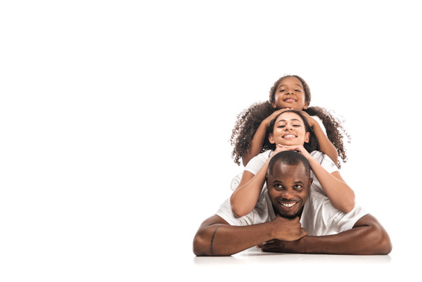 happy african american woman lying on back of each other and smiling at camera on white background - Photo, image