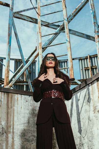 attractive model posing in trendy burgundy suit on urban roof - Фото, зображення