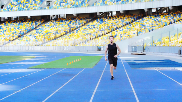 runner in sportswear running at stadium  - Video, Çekim