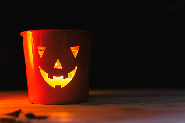Glowing Jack-o-lantern head in dark. Happy Halloween. Jack o lantern glowing face pumpkin on black background. Trick or treat. Copy space - 写真・画像