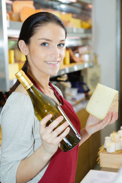 happy female brunette with different types of cheese in gastronomy - Photo, Image