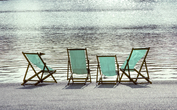 four empty deck chairs at the Hyde Park in London - Photo, Image