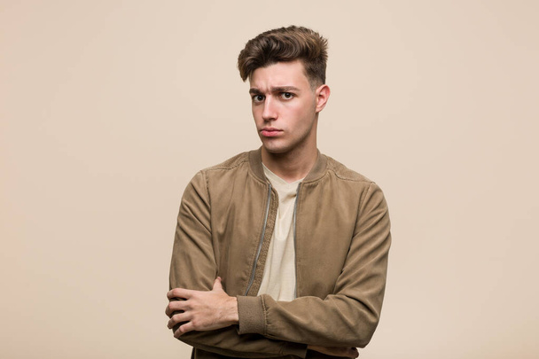 Young caucasian man wearing a brown jacket unhappy looking in camera with sarcastic expression. - Photo, Image