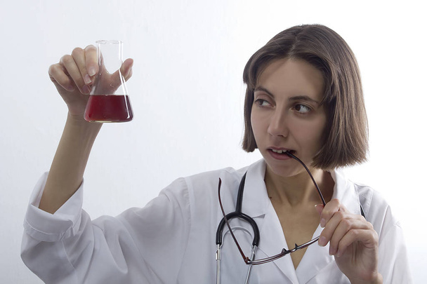 Doctor woman with stethoscope and flask - Φωτογραφία, εικόνα