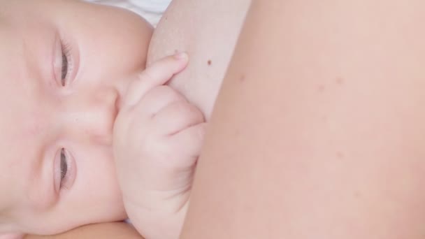 Shooting mother breastfeeding her little newborn baby at age of three months - Video, Çekim