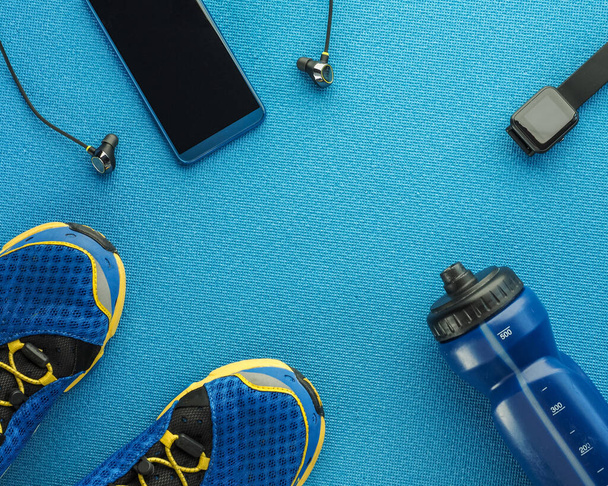 Sports equipment flat lay composition, running shoes, smartphone - Foto, imagen