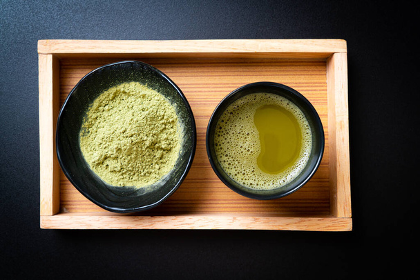 hot matcha green tea cup with green tea powder and whisk - Foto, imagen