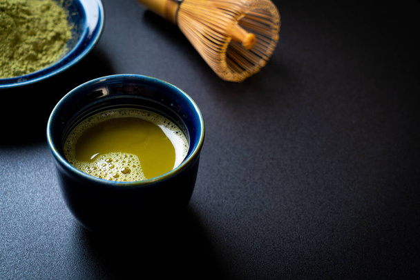 hot matcha green tea cup with green tea powder and whisk - Foto, immagini