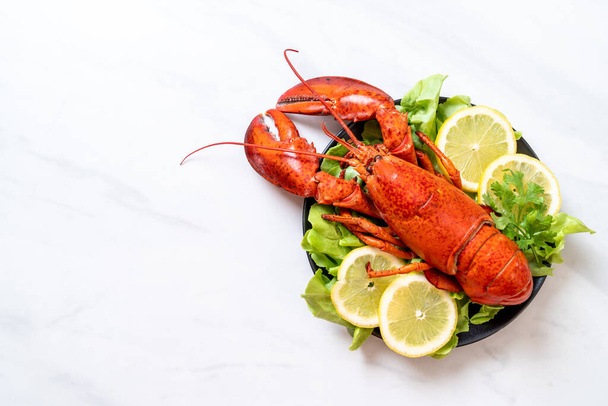 boiled lobster with vegetable and lemon - Фото, изображение