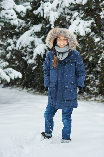 portrait of a beautiful caucasian girl on a background of snow-c - Photo, Image