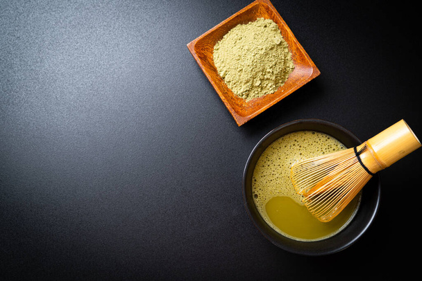 hot matcha green tea cup with green tea powder and whisk - Photo, Image