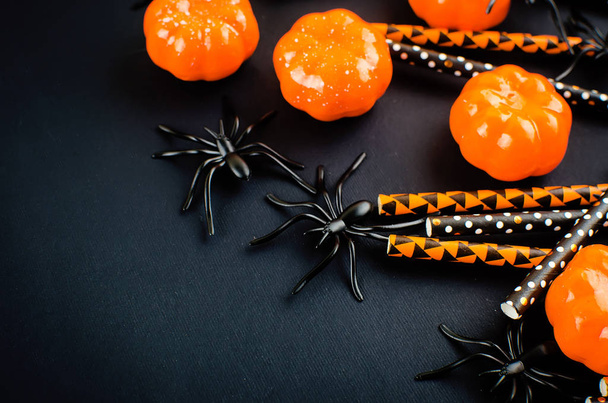 Halloween background with pumpkin, candy, eyes and spiders - 写真・画像