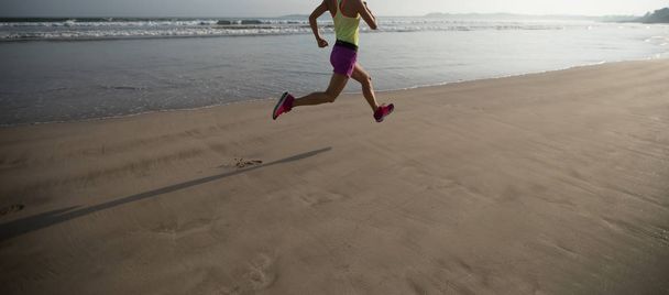 Young fitness woman running at beach - Fotografie, Obrázek